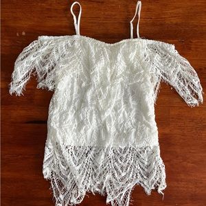 ‘No Boundaries’ white flowy shirt. Off the shoulder with straps.